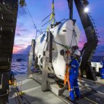 A technician checks the submarine DSV Limiting Factor aboard the research vessel DSSV Pressure Drop above the Pacific Ocean's Mariana Trench