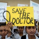 A doctor holds a placard at a government hospital during a strike demanding security after the recent assaults on doctors in Kolkata. Photo: Reuters