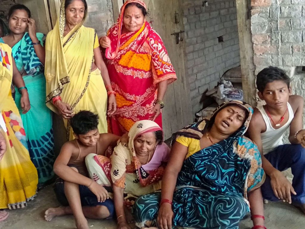 Family members mourn the death of labourers who were killed when a portion of the compound wall of a housing society collapsed on shanties adjacent to it in Kondhwa area of Pune. Photo: PTI