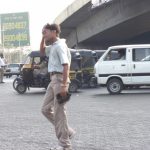 A pedestrian wipes his forehead as he walks in the heat, in Mumbai, April 2007. Photo: araswami/Flickr, CC BY 2.0