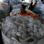 FILE PHOTO: A worker sorts used plastic bottles to be recycled at a plastic recycling centre in Denpasar, Bali