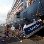 Passengers leave MS Westerdam, a cruise ship that spent two weeks at sea after being turned away by five countries over fears that someone aboard might have the coronavirus, as it docks in Sihanoukville