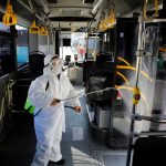FILE PHOTO: A worker in a protective suit disinfects a bus due to coronavirus concerns in Istanbul