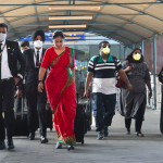 Airline staff and passengers wearing mask as preventive measure against the novel coronavirus at Chennai International Airport, Friday. Photo: PTI