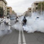 Members of firefighters wear protective face masks, amid fear of coronavirus disease, as they disinfect the streets, ahead of the Iranian New Year Nowruz, March 20, in Tehran