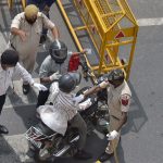 Coronavirus: Police personnel stop commuters