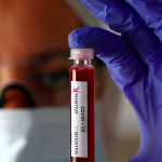 Fake blood is seen in test tubes labelled with the coronavirus (COVID-19) in this illustration taken March 17, 2020. Photo: Reuters/Dado Ruvic/Illustration