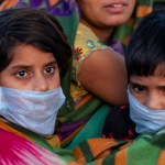 A migrant worker's family draped in blanket rests along a road as they return to their village, during a 21-day nationwide lockdown to limit the spreading of coronavirus disease (COVID-19), in New Delhi, India, March 30, 2020. Photo: Reuters/Danish Siddiqui