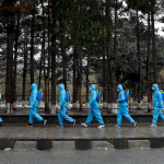 Volunteers prepare themselves to spray disinfectants on streets and shops amid concerns about coronavirus disease (COVID-19) in Kabul, Afghanistan March 30, 2020. Photo: Reuters/Mohammad Ismail