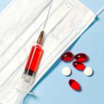 syringe-and-pills-on-blue-background-3786157
