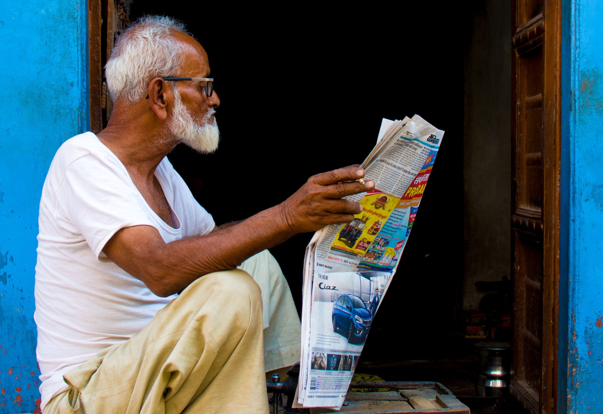 old-man-sitting-while-holding-newspaper-article-2248503
