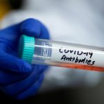 FILE PHOTO: Scientist Linqi Zhang shows a tube with a solution containing COVID-19 antibodies in his lab where he works on research into novel coronavirus disease (COVID-19) antibodies for possible use in a drug at Tsinghua University in Beijing