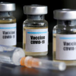 FILE PHOTO: Small bottles labeled with a "Vaccine COVID-19" sticker and a medical syringe are seen in this illustration