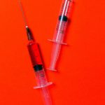 syringes-on-red-background-3786132f