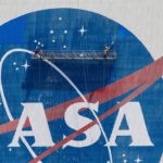 FILE PHOTO: Workers pressure wash the logo of NASA on the Vehicle Assembly Building, in Cape Canaveral