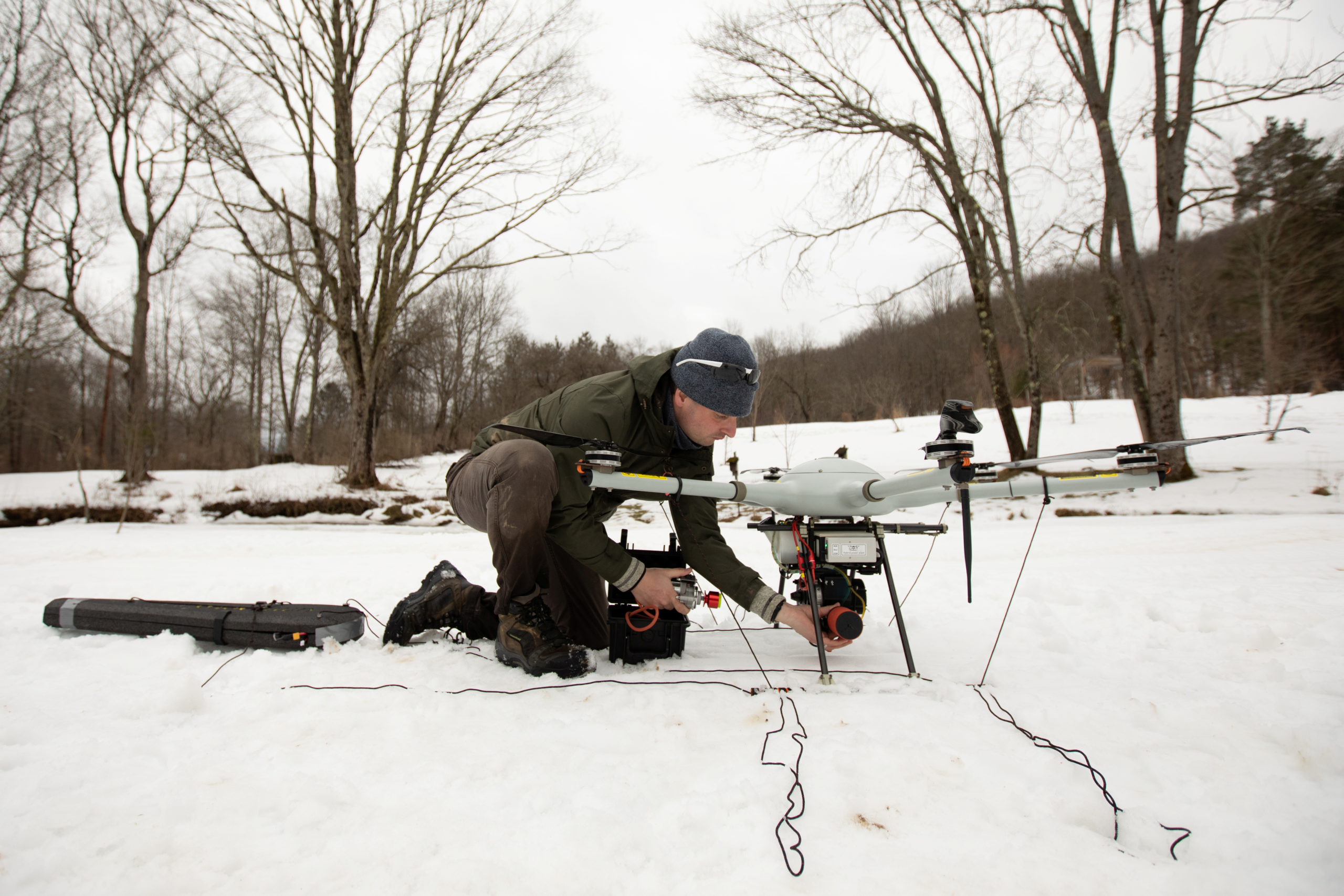 Alex Nikulin prepares a Ukrainian Multirotor Technologies (UMT) Cicada-M drone to fly with a magnetometer to detect abandoned oil wells in Olean, New York