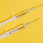 syringes-with-medical-drugs-on-yellow-background-4210557