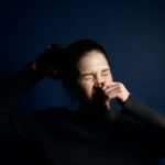 woman-touching-her-nose-395088