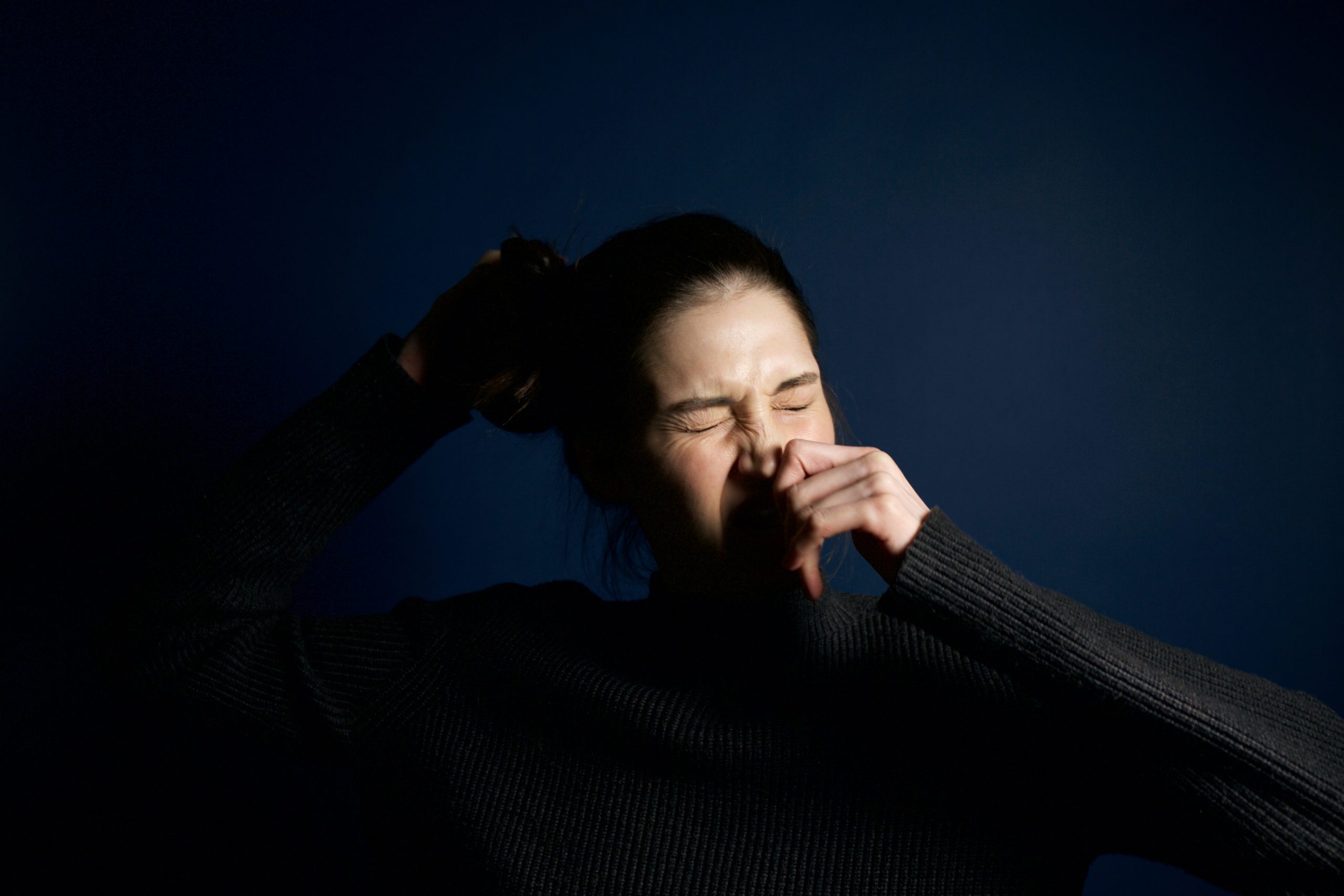 woman-touching-her-nose-395088