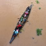 FILE PHOTO: Flood-affected villagers are transported by boat to safety at Kachua village