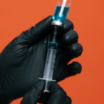 person-holding-a-vaccine-with-black-glovesvaccine-3952222