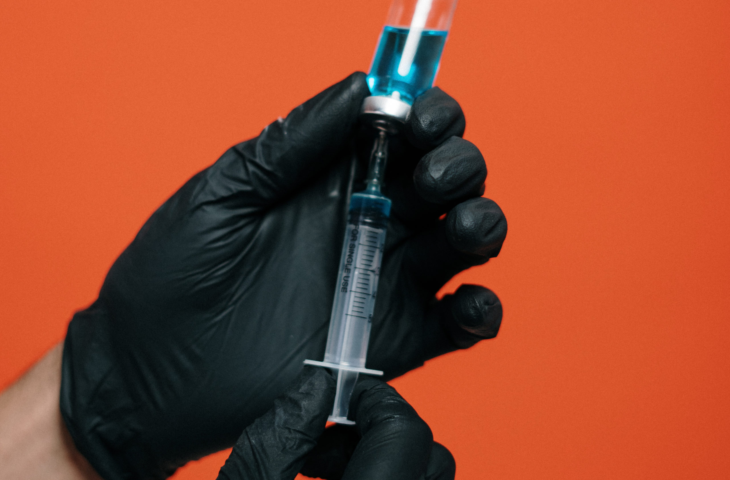 person-holding-a-vaccine-with-black-glovesvaccine-3952222