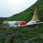 Officials inspect the site where a passenger plane crashed when it overshot the runway at the Calicut International Airport in Karipur