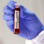 FILE PHOTO: Fake blood is seen in test tubes labelled with the coronavirus (COVID-19) in this illustration