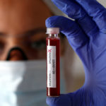 FILE PHOTO: Fake blood is seen in test tubes labelled with the coronavirus (COVID-19) in this illustration
