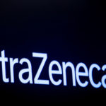 FILE PHOTO: The company logo for pharmaceutical company AstraZeneca is displayed on a screen on the floor at the NYSE in New York
