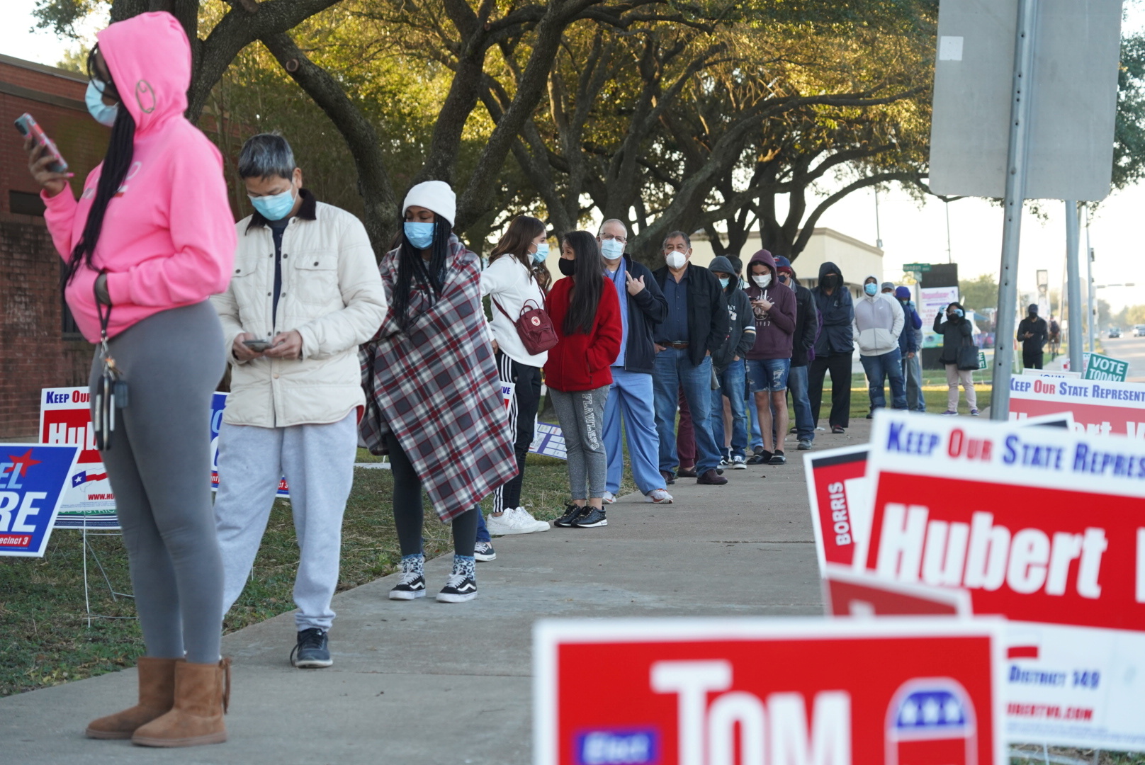 People line up outside a polling station during the Election Day in Houston