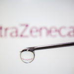 FILE PHOTO: AstraZeneca's logo is reflected in a drop on a syringe needle in this illustration