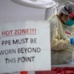 FILE PHOTO: A healthcare worker prepares specimen collection tubes at a coronavirus disease (COVID-19) drive-thru testing location in Houston