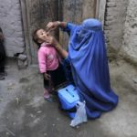 A child receives a polio vaccination during an anti-polio campaign on the outskirts of Jalalabad, Afghanistan