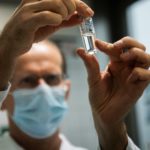 Laboratory assistant holds a tube with Russia's "Sputnik-V" vaccine against the coronavirus disease (COVID-19) at the National Institute of Pharmacy and Nutrition in Budapest