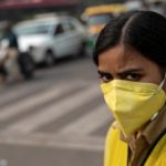 A policewoman wears a mask to protect herself from air pollution at a junction during restrictions on private vehicles based on registration plates on a smoggy morning in New Delhi