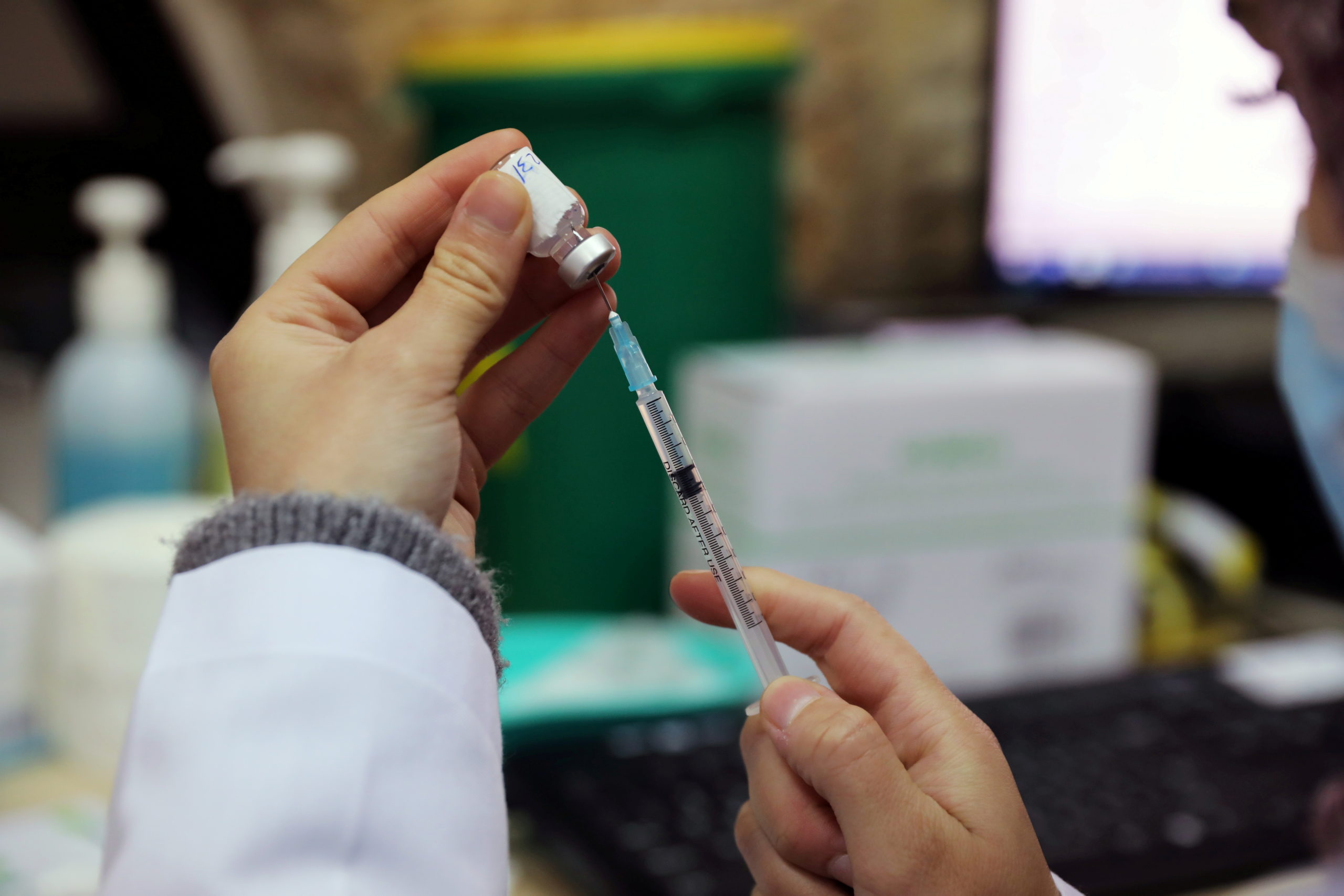 FILE PHOTO: A medical worker prepares a vaccination against the coronavirus disease (COVID-19) as Israel continues its national vaccination drive, in East Jerusalem