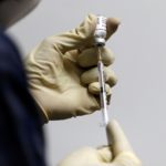 FILE PHOTO: A medic fills a syringe with COVAXIN, an Indian government-backed experimental COVID-19 vaccine, before administering it to a health worker during its trials, in Ahmedabad