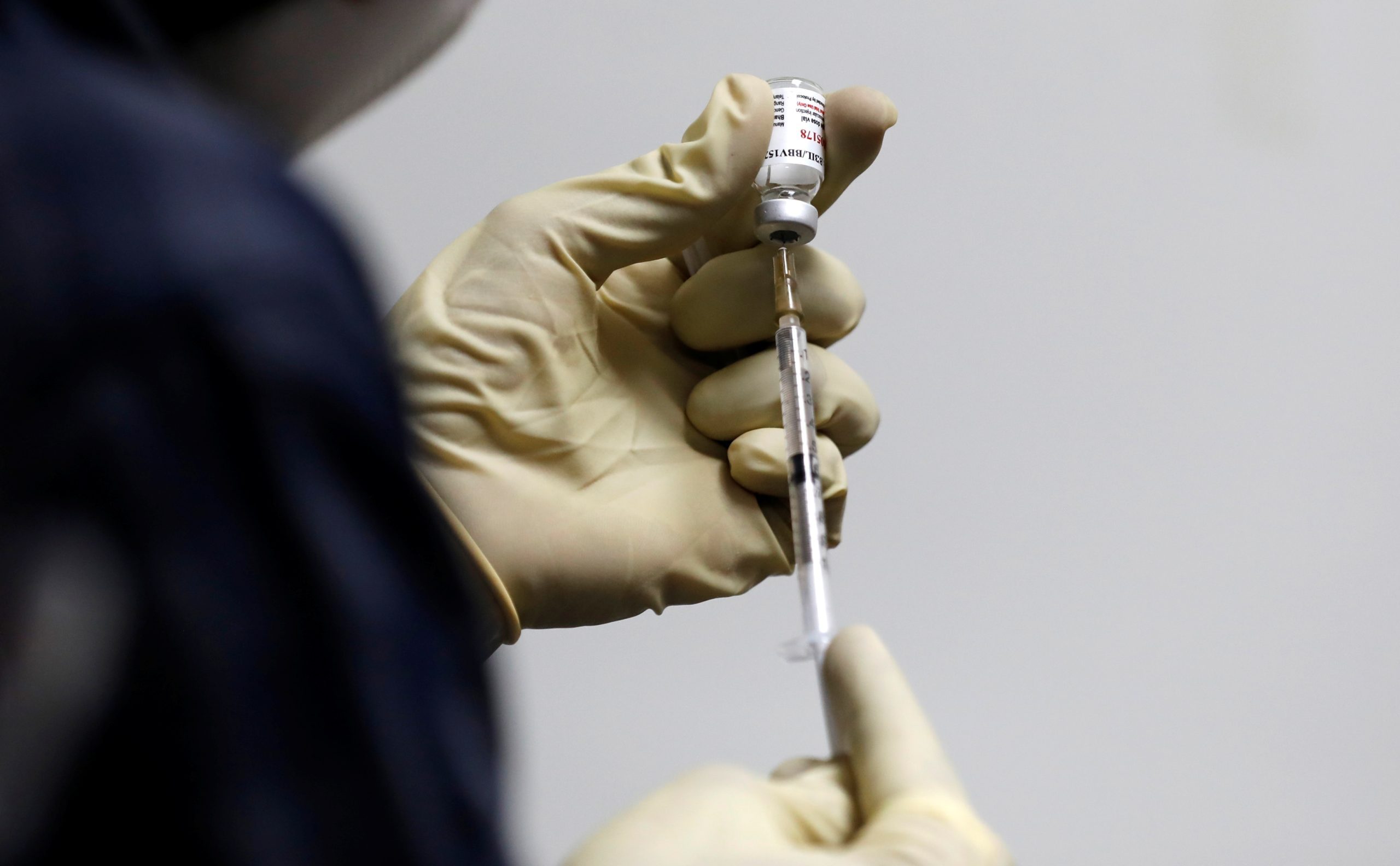 FILE PHOTO: A medic fills a syringe with COVAXIN, an Indian government-backed experimental COVID-19 vaccine, before administering it to a health worker during its trials, in Ahmedabad