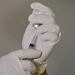 A paramedic fills a syringe with a vaccine against the coronavirus disease (COVID-19) before administering it to a health worker during its trials at Civil Hospital in Ahmedabad