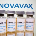 FILE PHOTO: Vials and medical syringe are seen in front of Novavax logo in this illustration