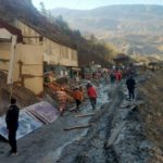Rescue team members work outside a tunnel after a part of a glacier broke away and caused flood in Tapovan