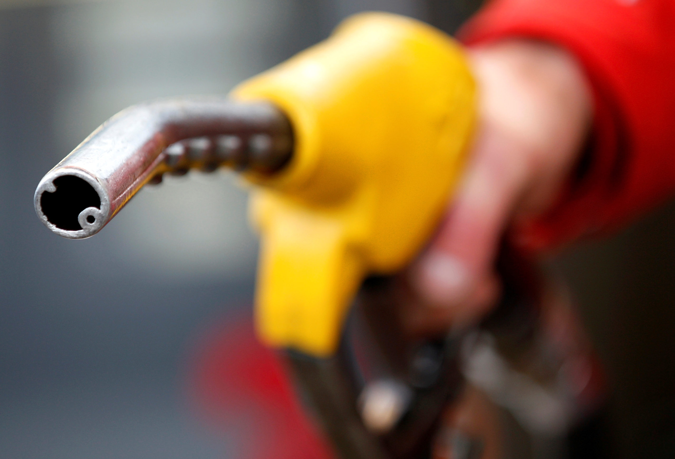 An attendant prepares to refuel a car at a petrol station in Rome. Photo: Reuters/Max Rossi/File Photo