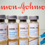 Vials and medical syringe are seen in front of J&J logo in this illustration. Illustration: Reuters/Dado Ruvic/Illustration