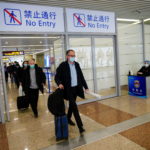 Members of the World Health Organisation (WHO) arrive at the airport in Shanghai