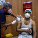 FILE PHOTO: A healthcare worker receives a dose of COVISHIELD at a hospital in Kolkata