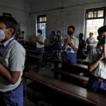Students pray inside their classroom in Ahmedabad