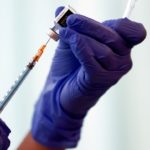 FILE PHOTO: A medical worker fills a syringe with a dose of the Pfizer-BioNTech coronavirus disease (COVID-19) vaccine as Japan launches its inoculation campaign, at Tokyo Medical Center in Tokyo