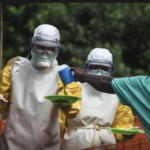Medical staff working with Medecins sans Frontieres (MSF) prepare to bring food to patients kept in an isolation area at the MSF Ebola treatment centre in Kailahun July 20, 2014. REUTERS/Tommy Trenchard