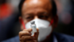 Indian Health Minister Harsh Vardhan holds a dose of Bharat Biotech's COVID-19 vaccine, Covaxin, during a vaccination campaign at All India Institute of Medical Sciences (AIIMS) hospital in New Delhi.